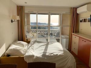 Un pat sau paturi într-o cameră la Village Vacances CAP ESTEREL , AGAY , T2 climatisé vue mer panoramique - accès de plain-pied au calme rare sur le site - Piscines et parking couvert inclus +27 fotografii