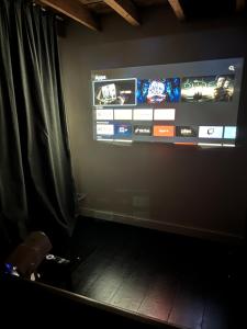 a room with a large screen with a tv on the wall at La Ronce Home in Écaussinnes-dʼEnghien