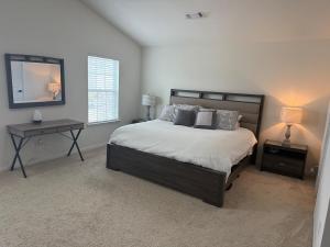 Un dormitorio con una cama, una mesa y un espejo. en Home in Dallas NC, en Dallas