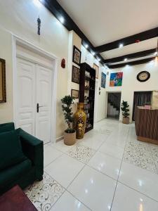 a living room with a green couch and a fireplace at Zaman Ya Zaman Boutique Hotel in Amman