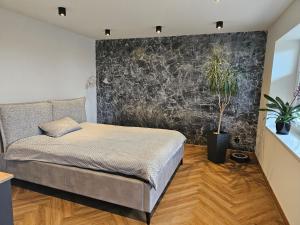 a bedroom with a bed and potted plants at Apartament Grańskie Zacisze in Raba Wyżna