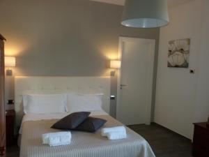 a bedroom with a bed with two pillows on it at Casa Nunna in Palma di Montechiaro