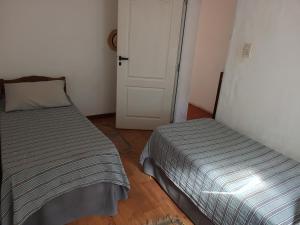 a bedroom with a bed and a door to a room at La Casita Junin in Junín