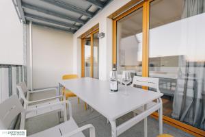 a dining room with a white table and chairs at 88 QM - Exklusiv & Top angebunden - Werse Loft by youpartments in Münster