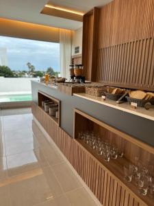 a kitchen with a counter with wine glasses on it at Urban Suites Oliva in Oliva +24 photos