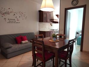 a living room with a table and a couch at La casetta di Ste in Pigna