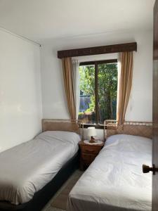two beds in a room with a window at Villa Herrero in La Adrada +51 photos