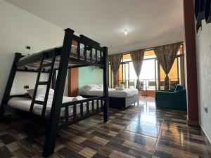 a bedroom with two bunk beds and a living room at Finca Hotel Villa Tara in Barbosa