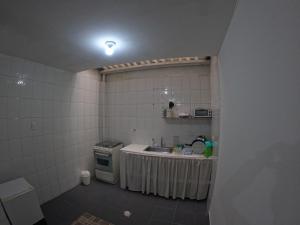 a small kitchen with a sink and a stove at Bacata Housing in Bogotá
