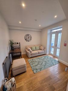 a living room with a couch and a table at Newly Refurbished Townhouse in Derry Londonderry