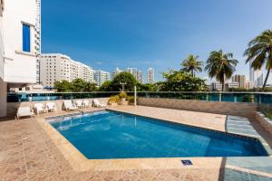 a swimming pool with a view of the city at Lindo Apartamento en cartagena el laguito bocagrande con vista al mar in Cartagena de Indias