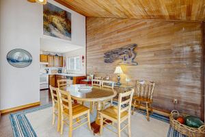 a kitchen and dining room with a table and chairs at At The Seaside in Lincoln Beach