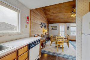 a kitchen and dining room with a table and chairs at At The Seaside in Lincoln Beach +16 photos