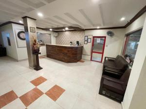 a lobby with a bar in the middle of a room at Citymax Hotel in Rawalpindi