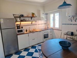 a kitchen with a table and a refrigerator at Riverfront 2 Bedrooms with Balcony in Cruz Quebrada