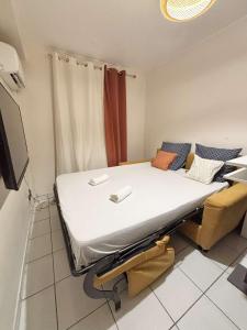a hospital room with a bed and a tv at Le Tiny Studio in Saint-Denis