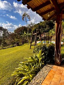 a porch of a resort with a garden and a playground at Santa Elena Ventanas Parapente Bed and Breakfast Premium in Santa Helena