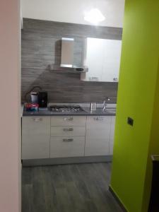 a kitchen with a sink and a stove top oven at Casa Nunna in Palma di Montechiaro