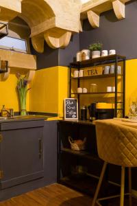 una cocina con paredes amarillas y azules y una mesa. en Escape to a Unique 2 Bed Apt in Heart of Valletta, en La Valeta