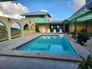 a swimming pool in the backyard of a house at The View in Christiansted