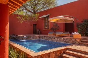 a swimming pool in the backyard of a house at Hotel Casa De Quino in Querétaro
