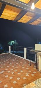 a balcony with a table and a view of the ocean at cabaña el huricho in Mazamitla