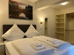 a bed with two towels on top of it at Eifelerhof hotel Monschau in Monschau +59 photos