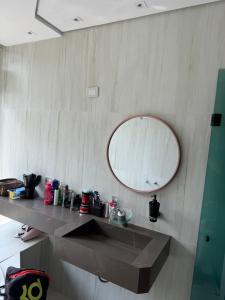 a bathroom with a sink and a mirror on the wall at Chácara Meu Pedaço Atibaia in Mairiporã +48 photos