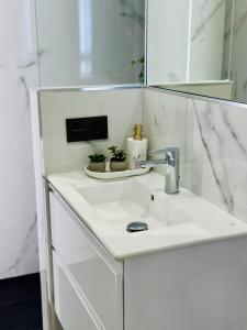 a white bathroom with a sink and a mirror at Mark Suite B8 in Fuengirola +30 photos