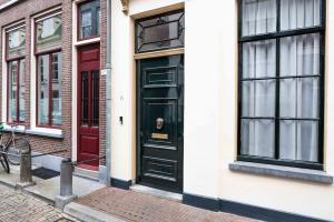 a pair of black doors on a building at Zocher6 a monumental town house in the city center in Utrecht