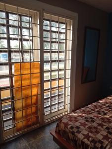 a bedroom with large windows and a bed in a room at Townhouse en Chichiriviche AGUILA MARINA 3 in Chichiriviche +8 photos