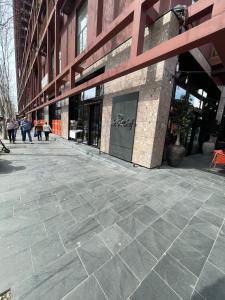 a building with people walking in front of it at Garden Building Luxury Apartment in Tirana