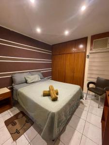 a bedroom with a bed with two logs on it at Apartamento Maracay Base Aragua in Maracay