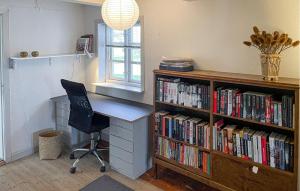 an office with a desk and a book shelf with books at Cozy Home In Horslunde With Wifi in Horslunde