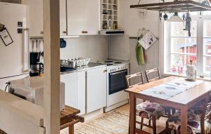 a kitchen with a wooden table and a dining room at Pet Friendly Home In Julita in Julita