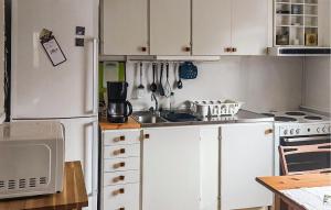a kitchen with white cabinets and a white refrigerator at Pet Friendly Home In Julita in Julita