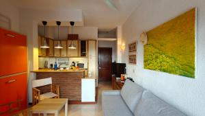 a living room and kitchen with a couch and a table at Puerta del Mar, primera línea de playa in Almuñécar