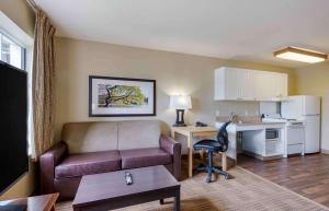 a living room with a couch and a desk at Extended Stay America Suites - Greensboro - Airport in Greensboro