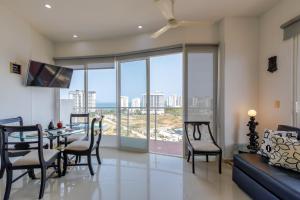 a living room with a table and chairs and a couch at Terrazas Rodadero Santa Marta in Santa Marta