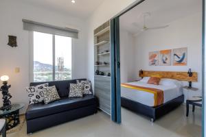 a bedroom with a bed and a couch at Terrazas Rodadero Santa Marta in Santa Marta +50 photos