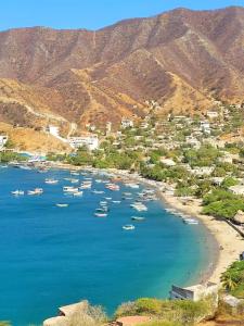 a group of boats in the water on a beach at Studio apartment in the mountains in Santa Marta