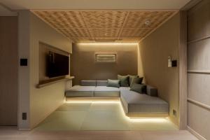 a living room with a couch and a television at MOKU Kyoto in Nishinotōindōri