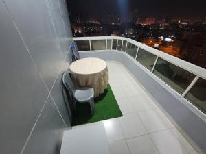 a balcony with a table and chairs on a building at Seaside 1BR Perfect Getaway in Ajman 