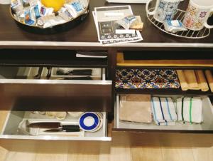 an open drawer in a kitchen with food at Trieste Apartment in Reggio di Calabria +42 photos