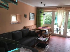 a living room with a couch and a table at Ferienhaus in Zandt mit Kleiner Terrasse in Zandt +13 photos