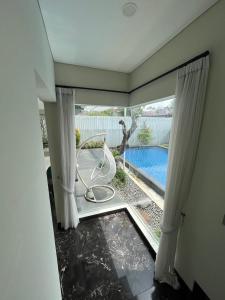 a room with a view of a pool through a window at Cipedes Mansion in Bandung +2 photos