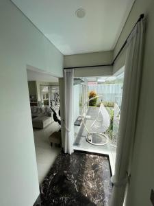 a living room with a view of a living room with a window at Cipedes Mansion in Bandung