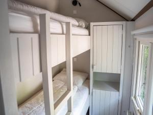 two bunk beds in a room with a window at Farmhouse in Veluwe near Speulderbos in Ermelo