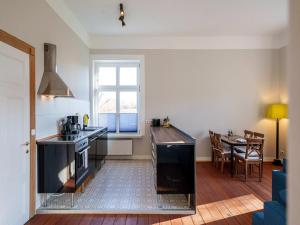 a kitchen and dining room with a table and a window at Manor Lakeside Escape in Laase