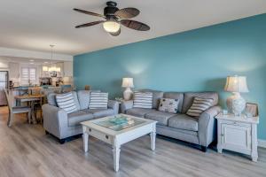 a living room with a couch and a table at Kid Friendly Condo with Stunning View of the Atlantic in Fernandina Beach